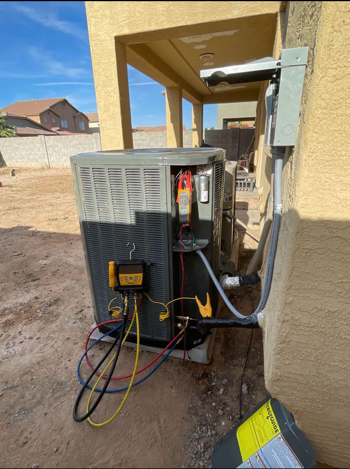 An air conditioner is being installed on the side of a building.