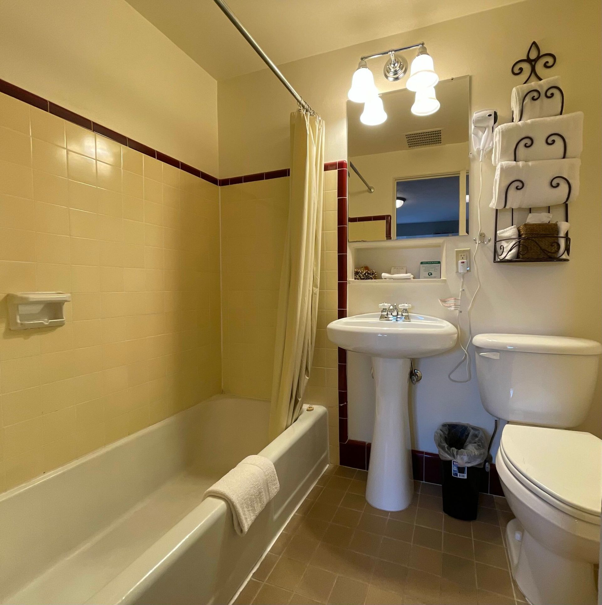 A bathroom with a sink toilet and bathtub