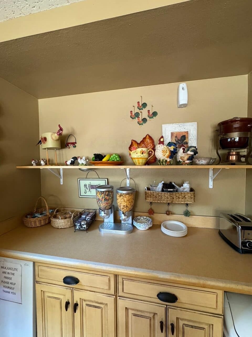 A kitchen with wooden cabinets and shelves filled with various items