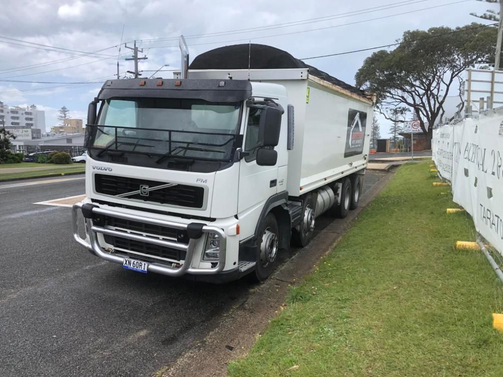 A White Dump Truck is Parked on the Side of the Road — BDM Heavy Vehicle Repairs In Wauchope, NSW