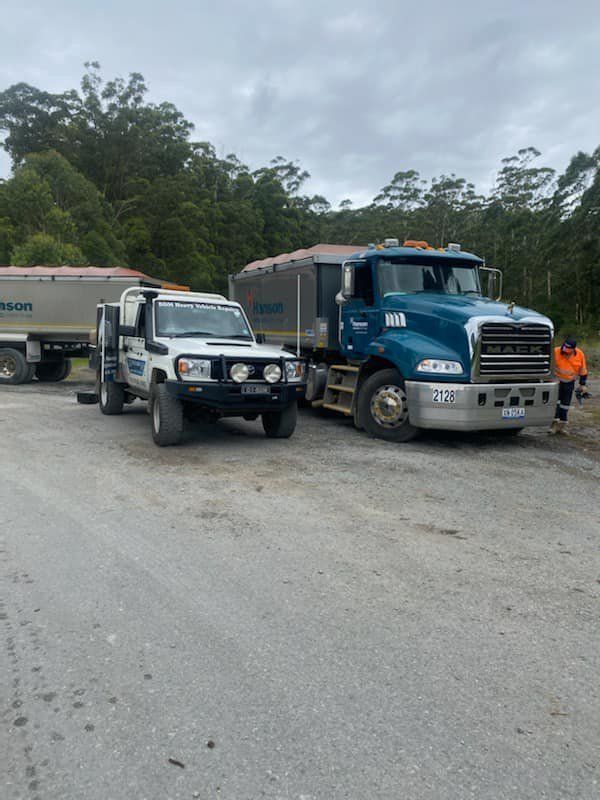 Two Trucks Are Parked Next to Each Other on the Side of the Road — BDM Heavy Vehicle Repairs In Wauchope, NSW
