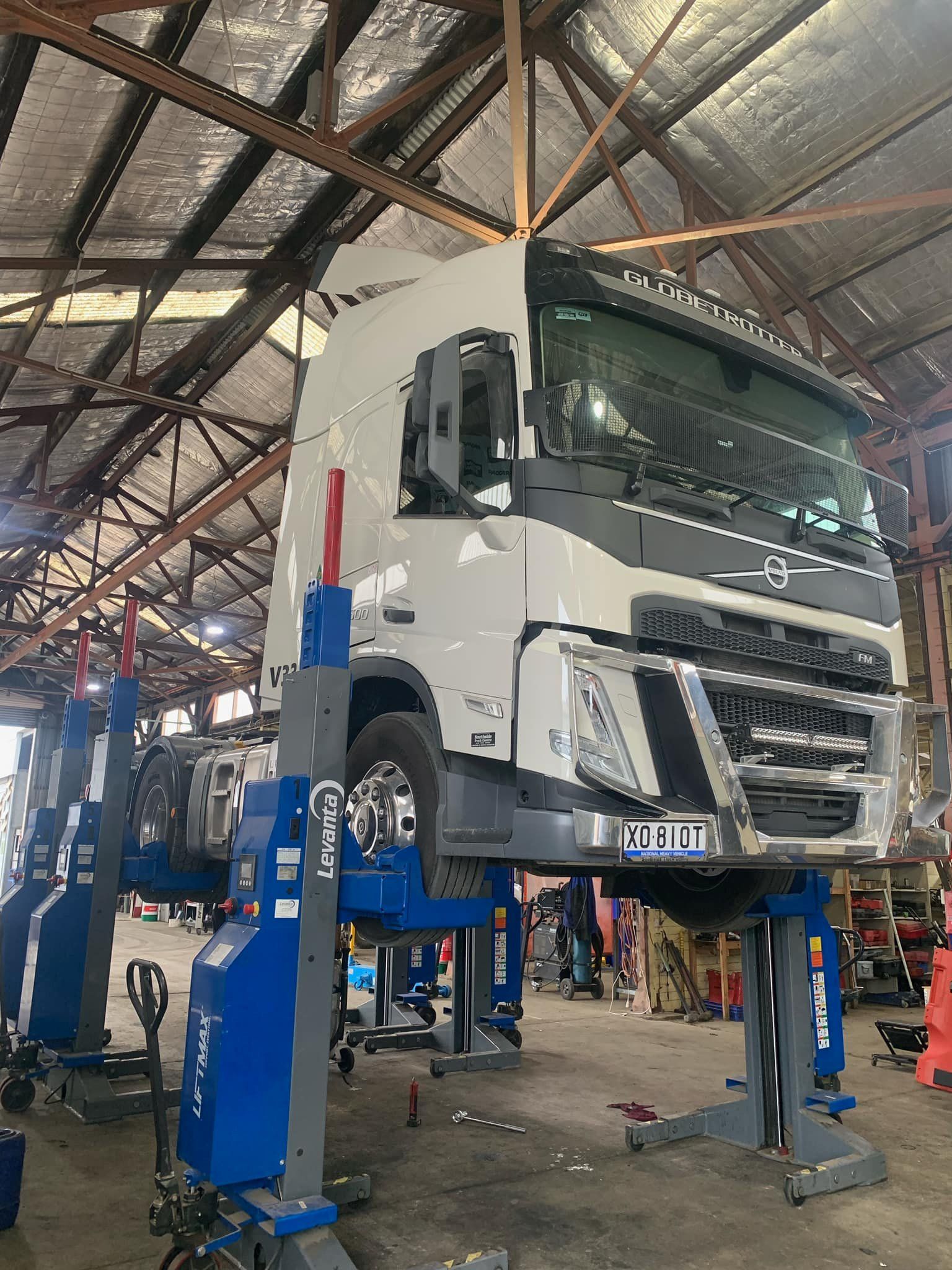 A truck is sitting on a lift in a garage.— BDM Heavy Vehicle Repairs In Wauchope, NSW