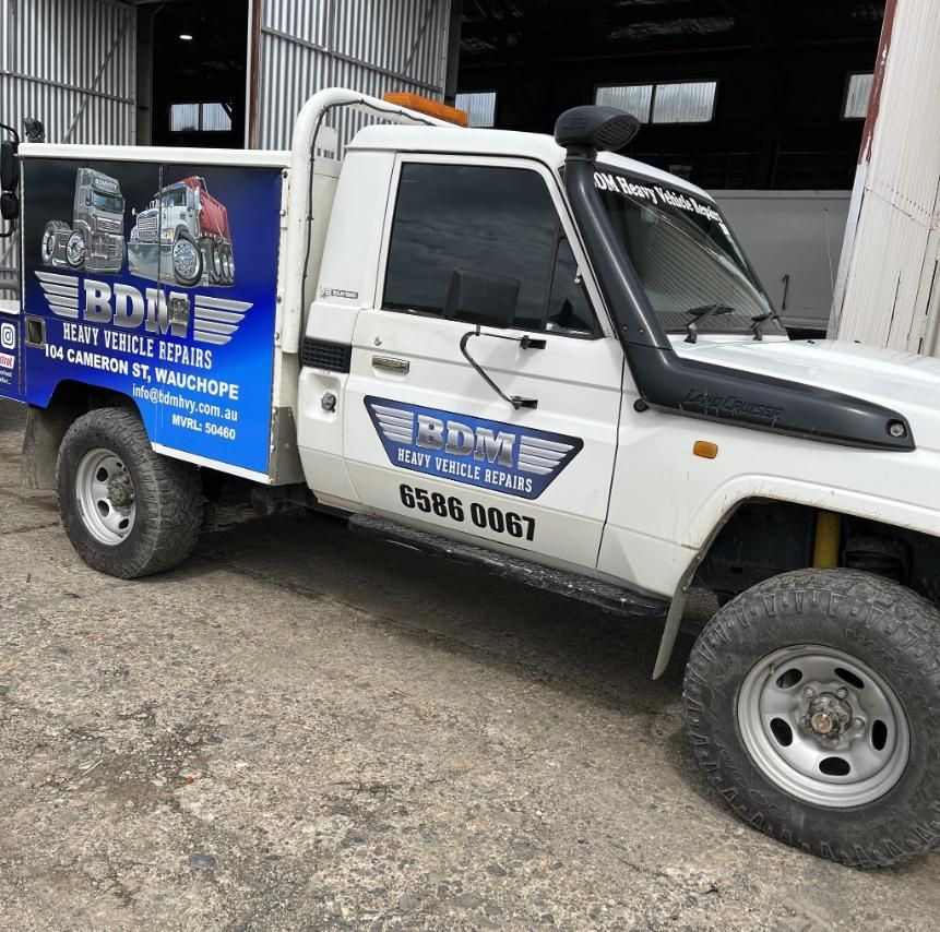 A White Truck is Parked in Front of a Building — BDM Heavy Vehicle Repairs In Wauchope, NSW