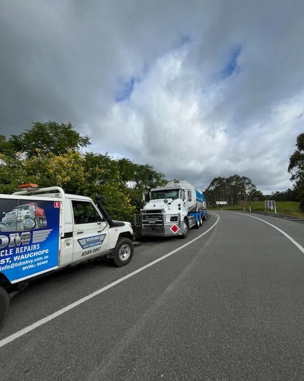 A Truck is Being Towed by a Tow Truck — BDM Heavy Vehicle Repairs In Wauchope, NSW