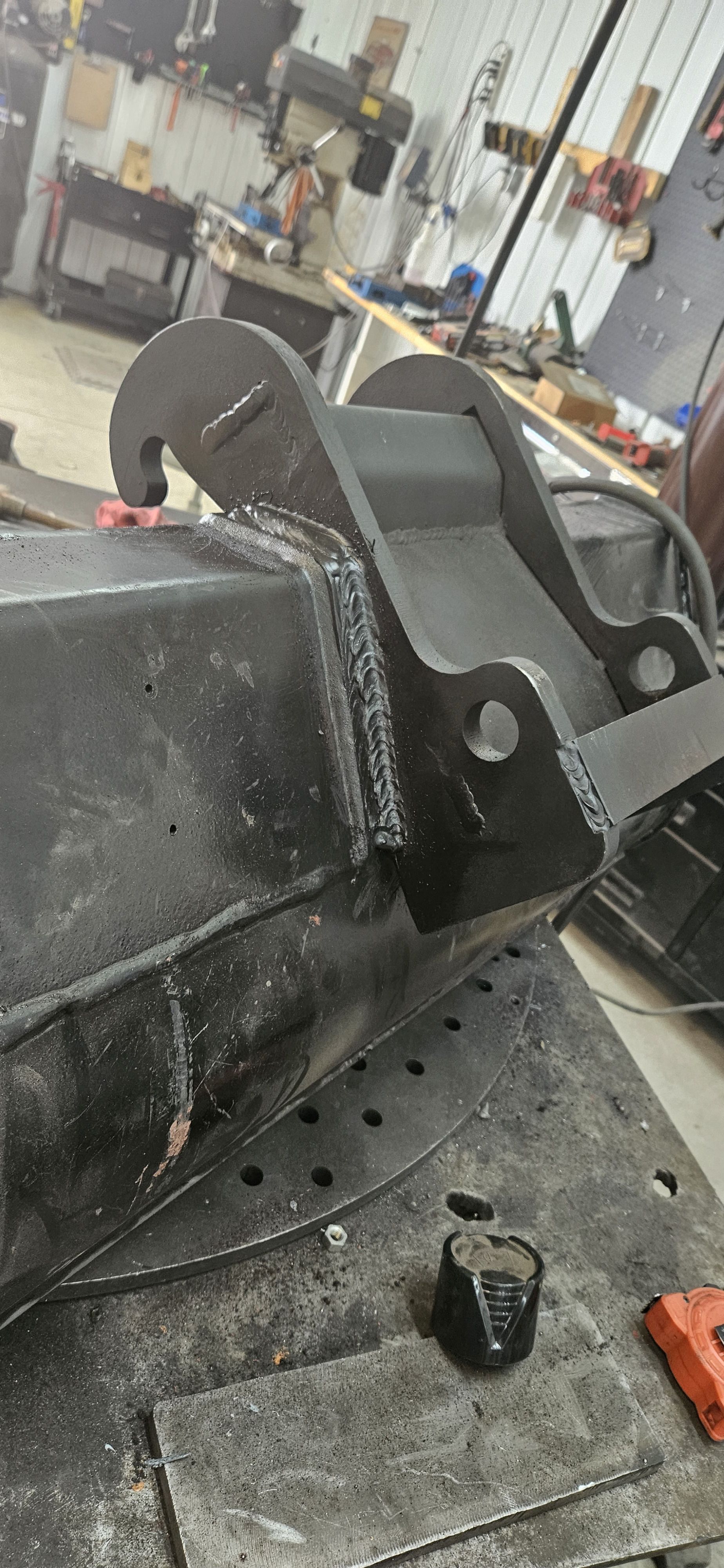 A piece of metal is sitting on top of a table in a workshop.