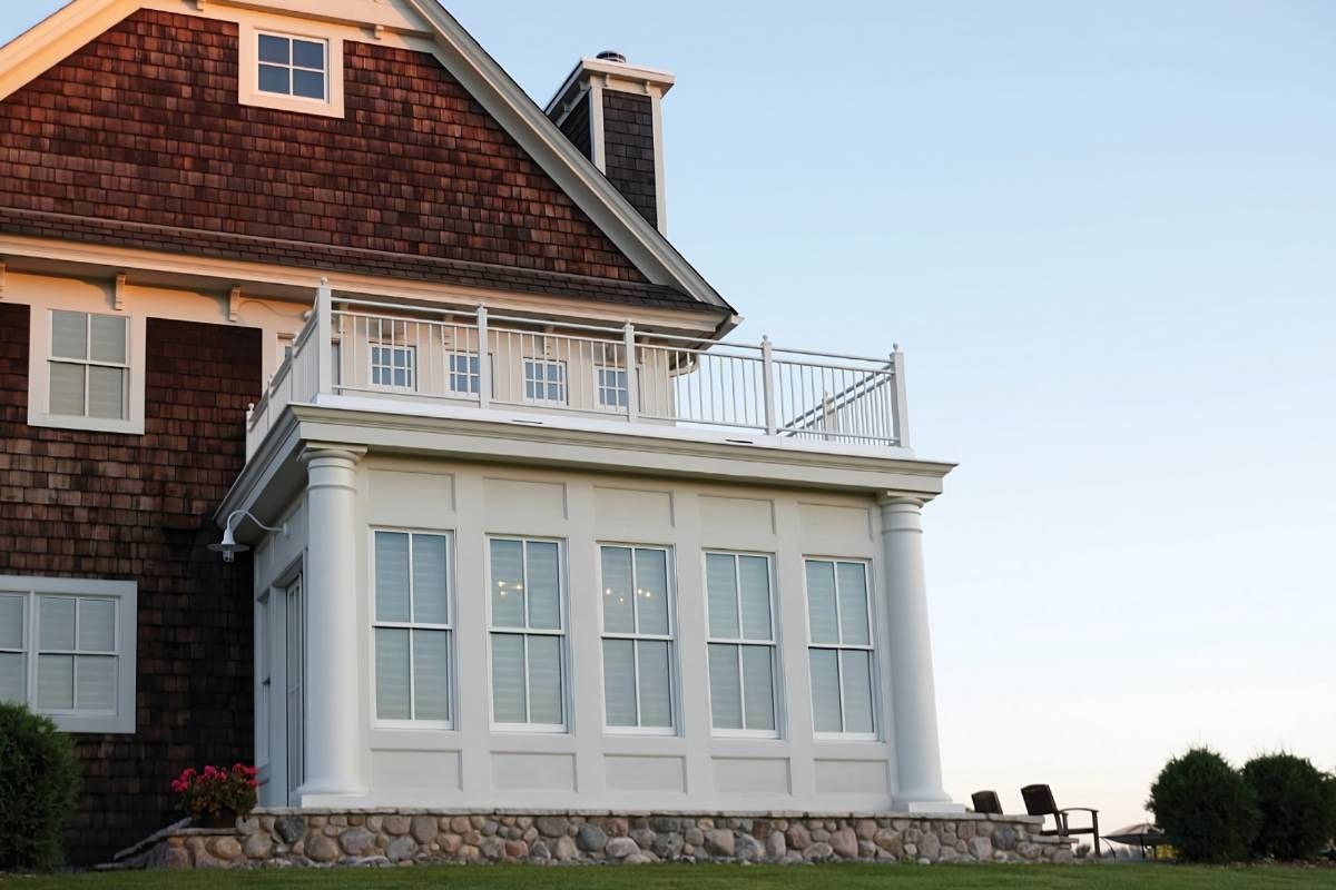 An exterior shot of a home with several windows dressed in Hunter Douglas Silhouette® Sheer Shades near Houston, TX