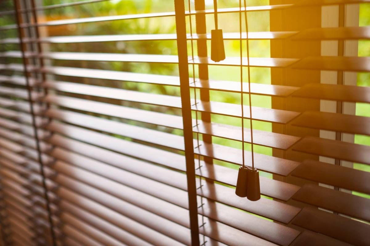 open wood blinds letting in sunlight near Houston TX