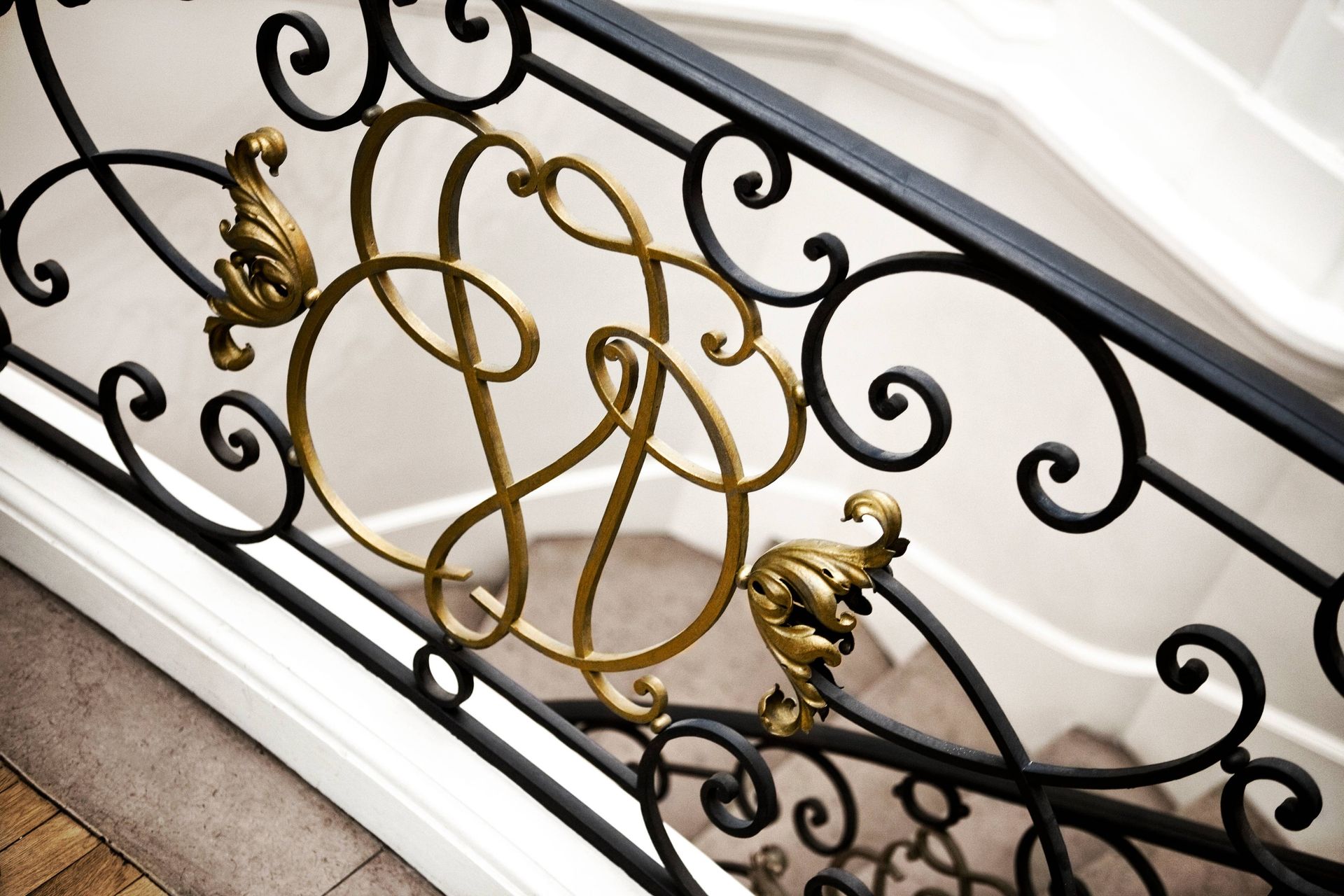 Stunning gold and black faux iron detailing on a stair railing inside a residential home near Houston, TX