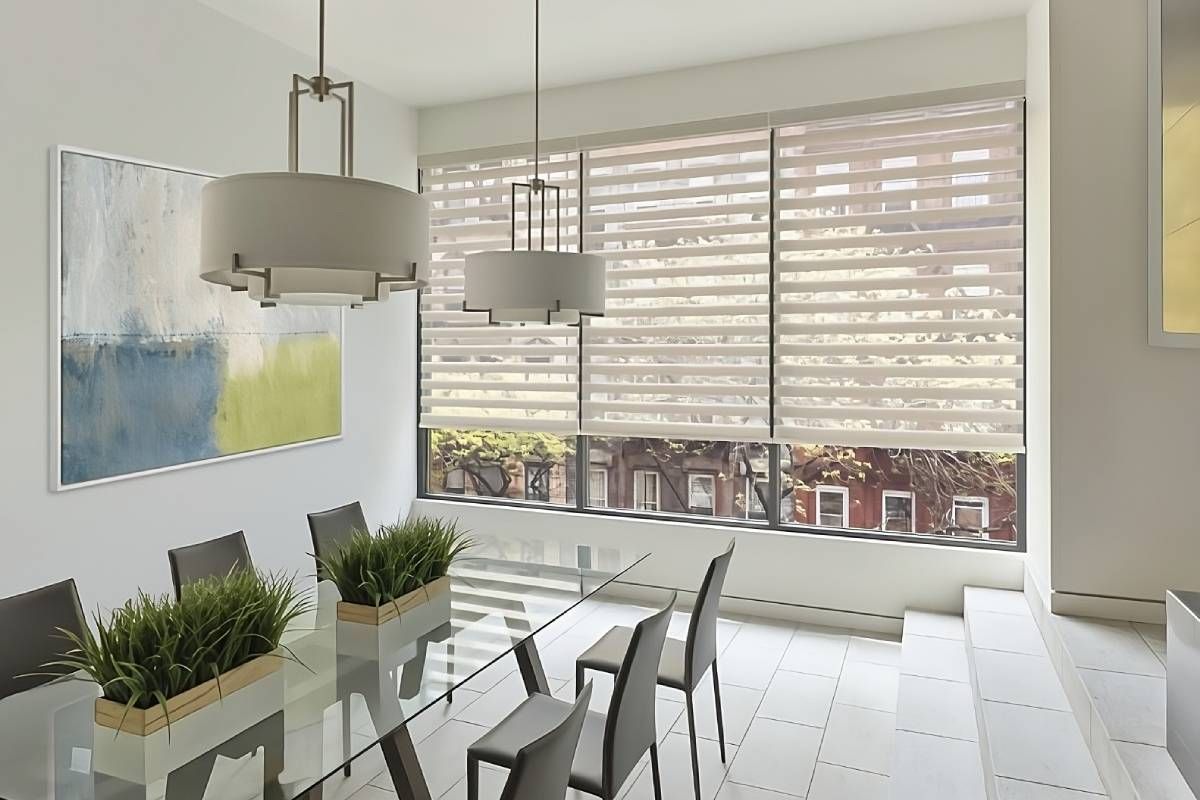 Hunter Douglas Designer Banded Shades, a type of roller shade, on large dining room windows near Houston, TX