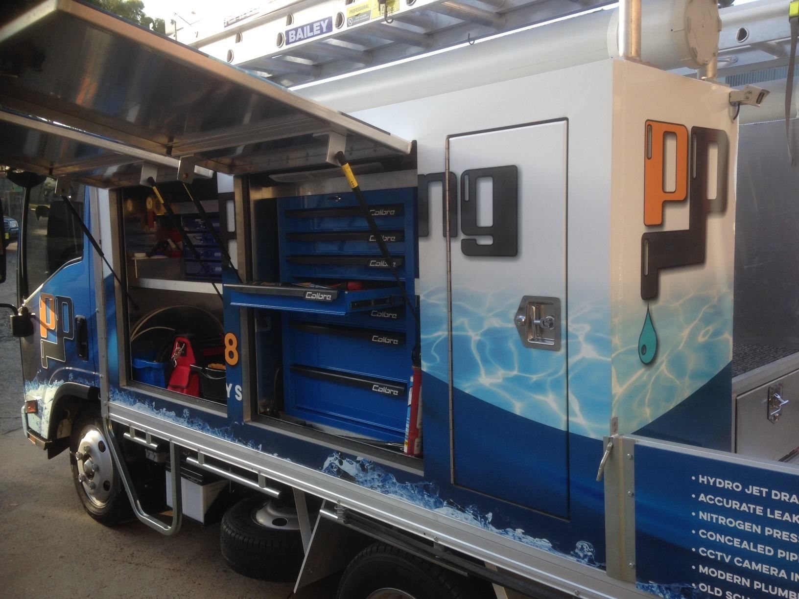 Service Truck With Open Compartments — Port Macquarie Plumbing In Port Macquarie, NSW