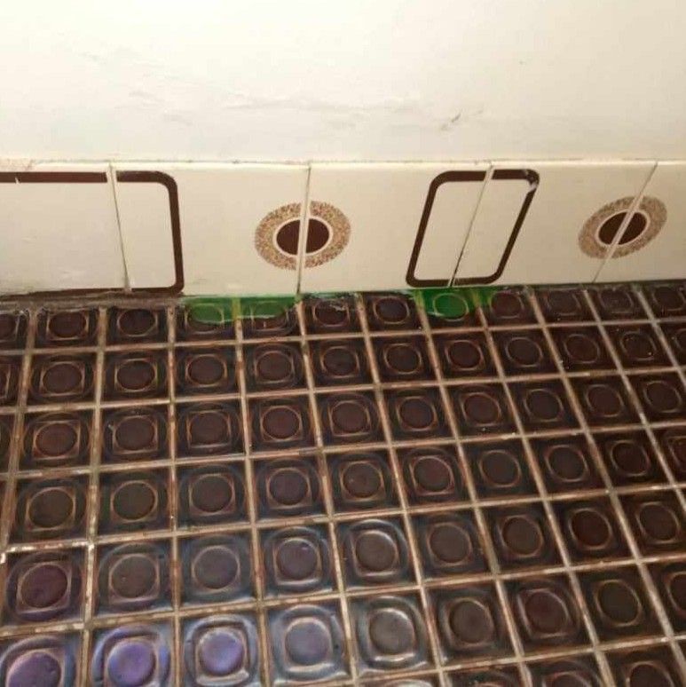 Close-up of a Tiled Bathroom Floor and Wall — Port Macquarie Plumbing In Port Macquarie, NSW