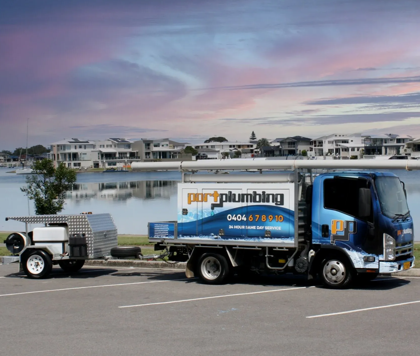 A Fleet of Work Trucks Parked Outside a Facility — Port Macquarie Plumbing In Port Macquarie, NSW
