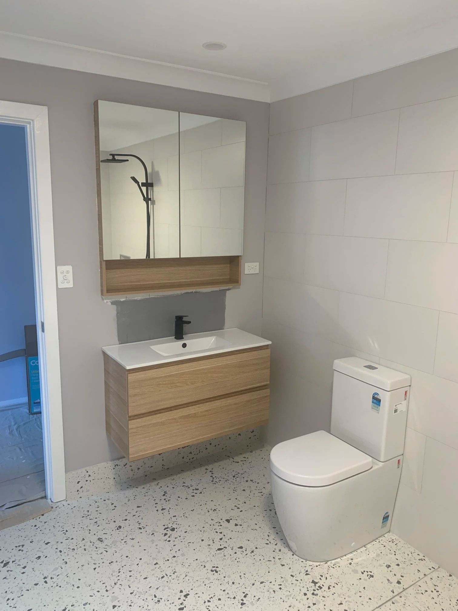 A Bathroom With a Floating Light-wood Vanity — Port Macquarie Plumbing In Port Macquarie, NSW