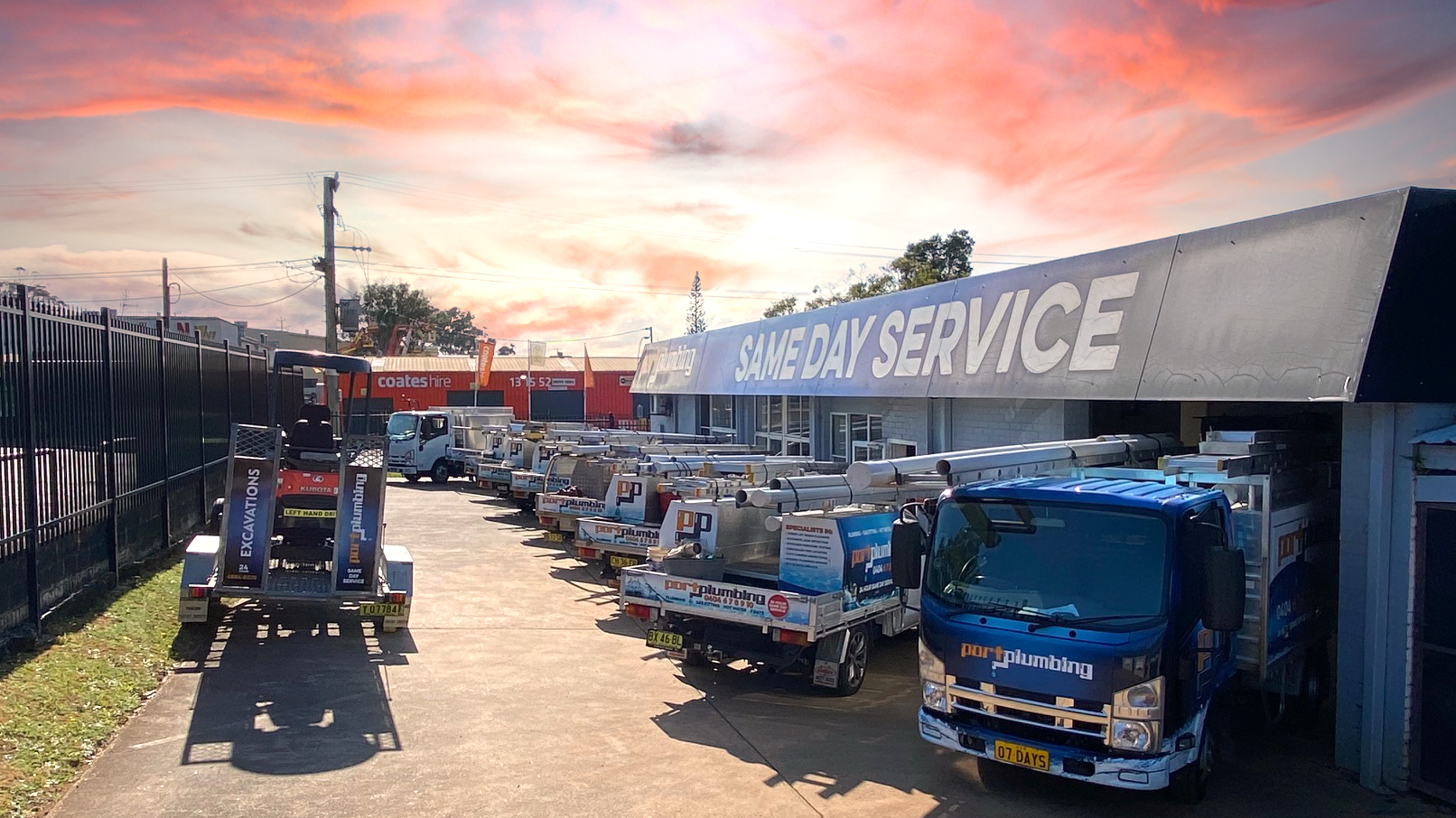 A Row of Parked Service Trucks and Machinery — Port Macquarie Plumbing In Port Macquarie, NSW