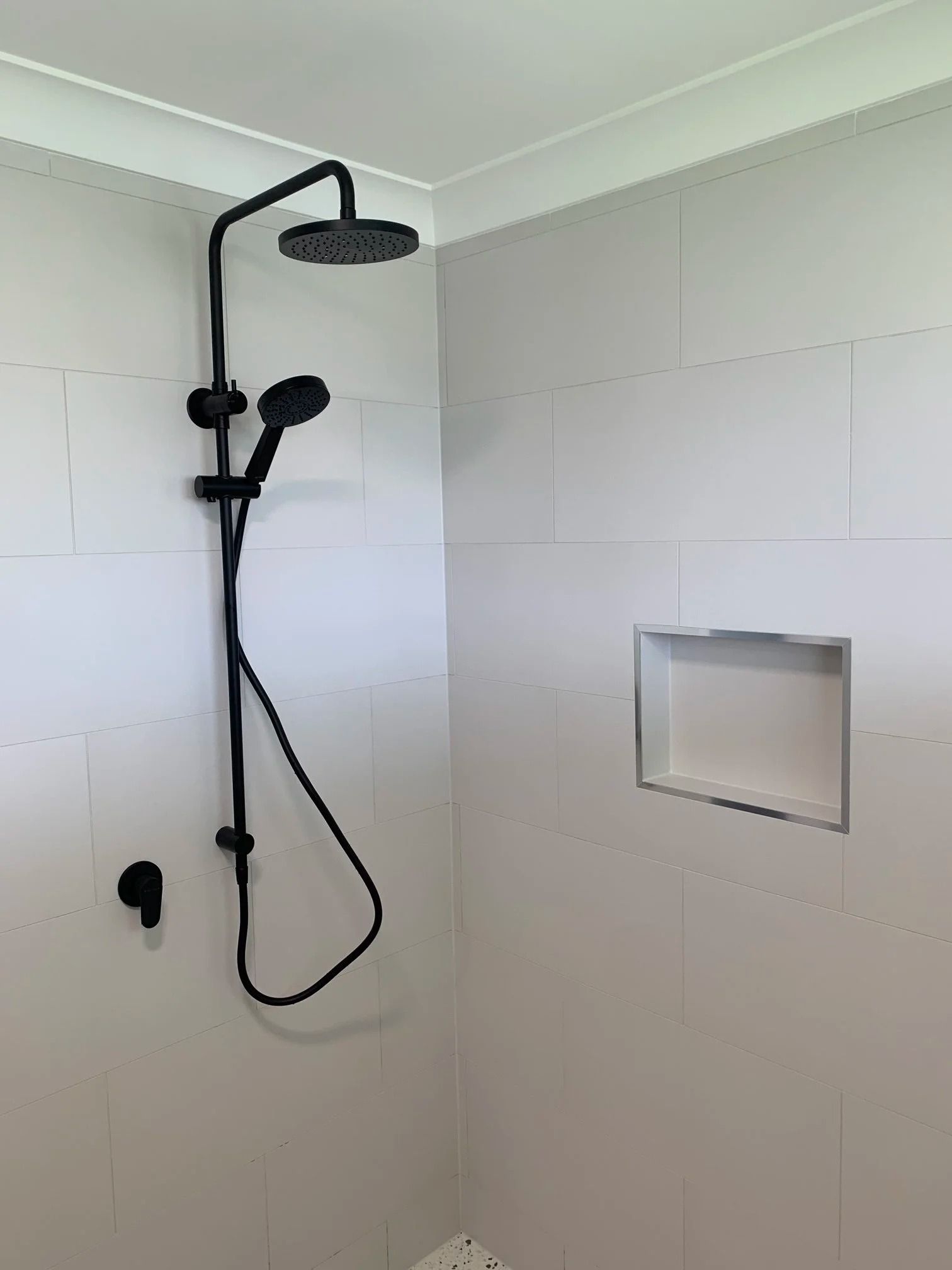 A Matte Black Shower Fixture With a Rainfall Head and Handheld Sprayer — Port Macquarie Plumbing In Port Macquarie, NSW