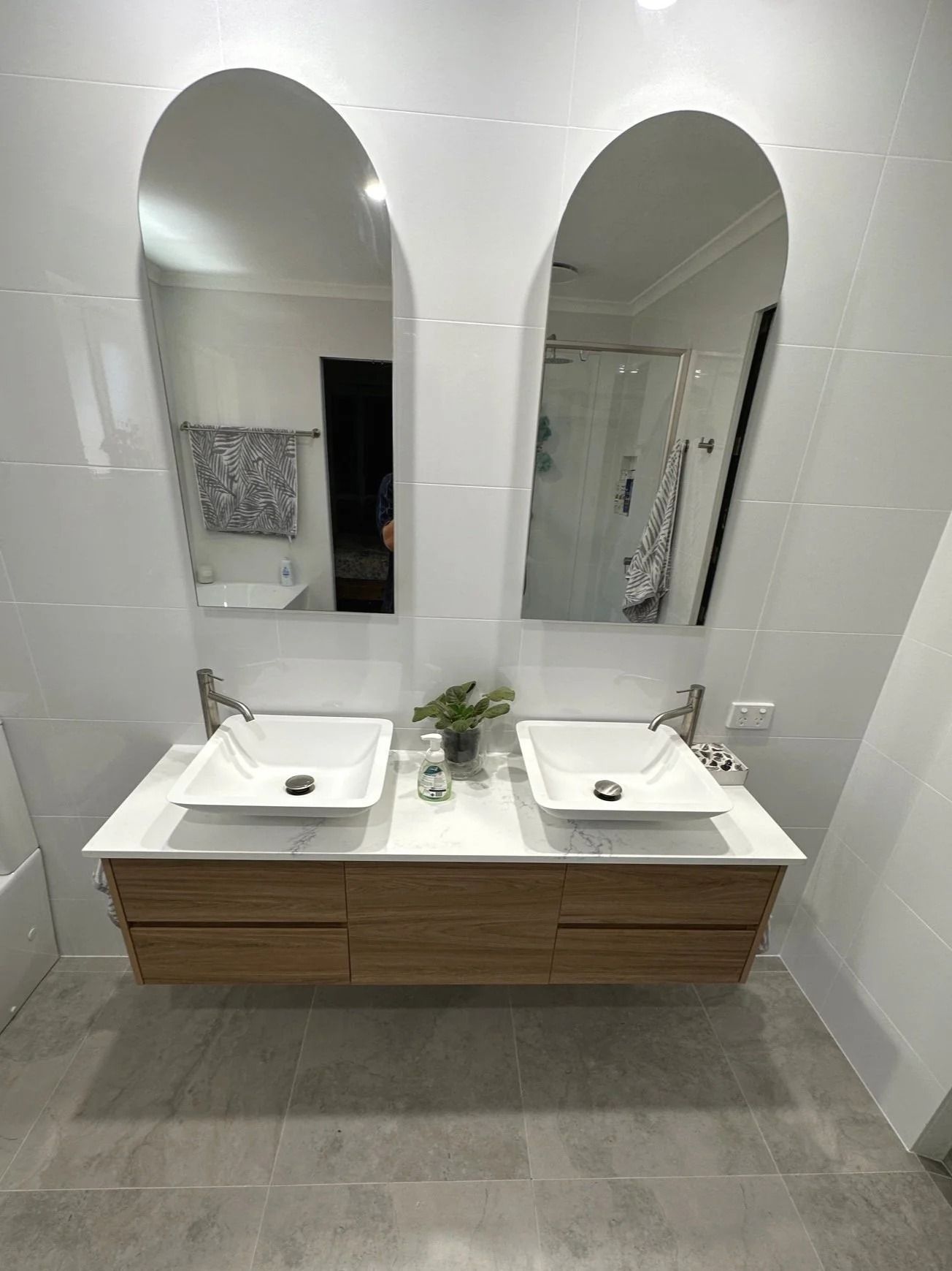 A Modern Bathroom Vanity With Dual Square White Sinks and Two Arched Mirrors — Port Macquarie Plumbing In Port Macquarie, NSW