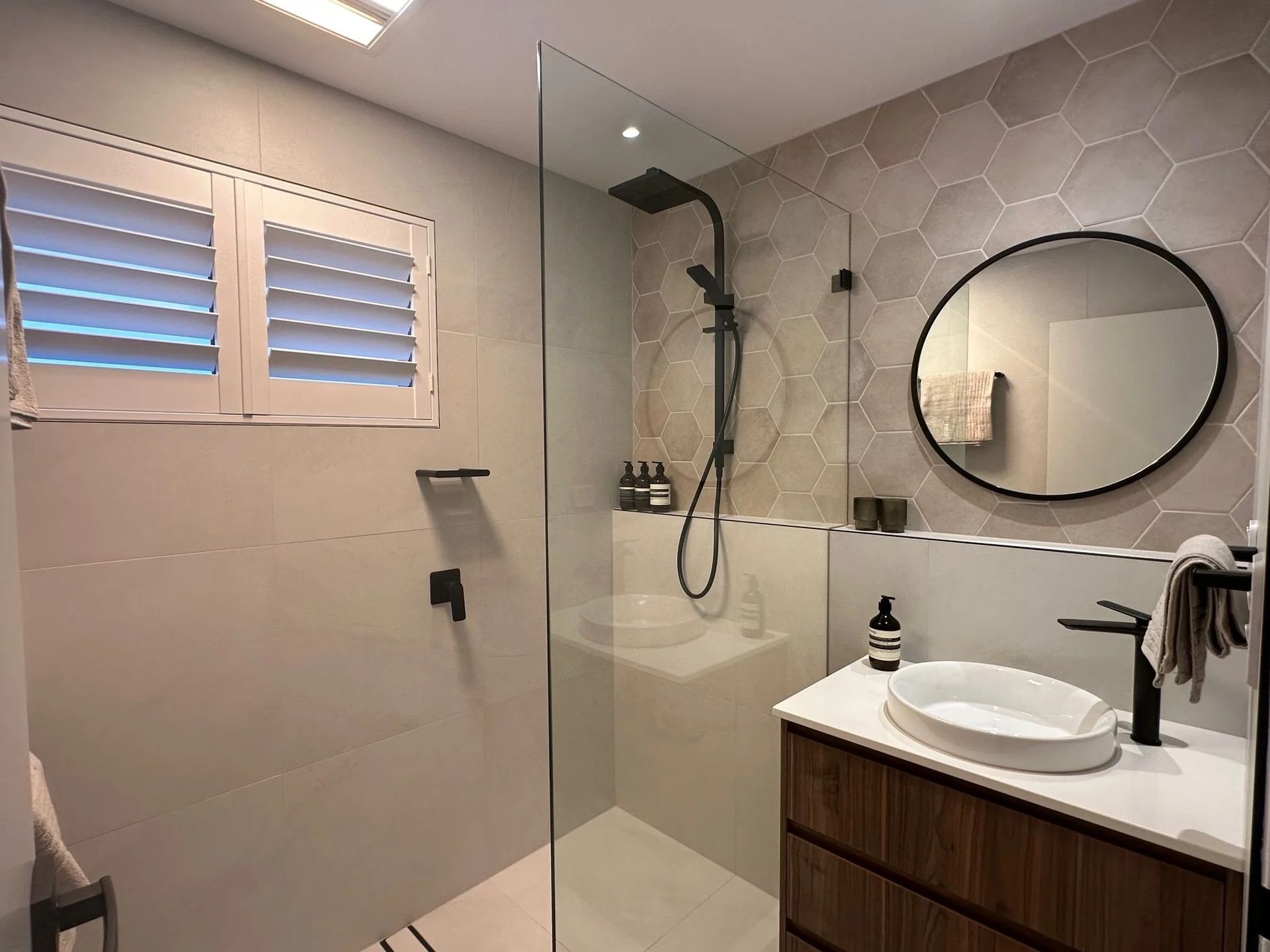 A Modern Bathroom Featuring a Wooden Vanity — Port Macquarie Plumbing In Port Macquarie, NSW
