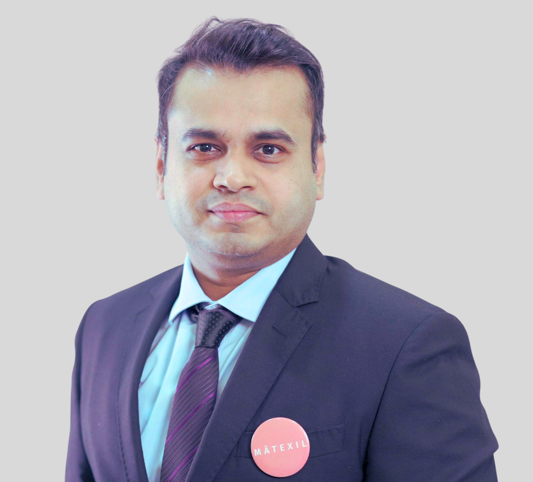 A man in a suit and tie has a button on his pocket that says matrix