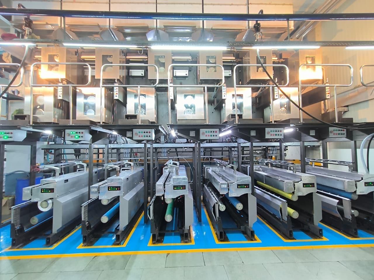 A warehouse filled with lots of rolls of paper