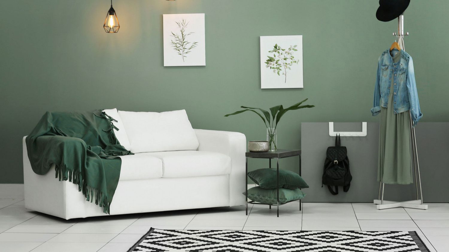 Stylish living room with green walls and white furniture, ideal for pest control solutions.
