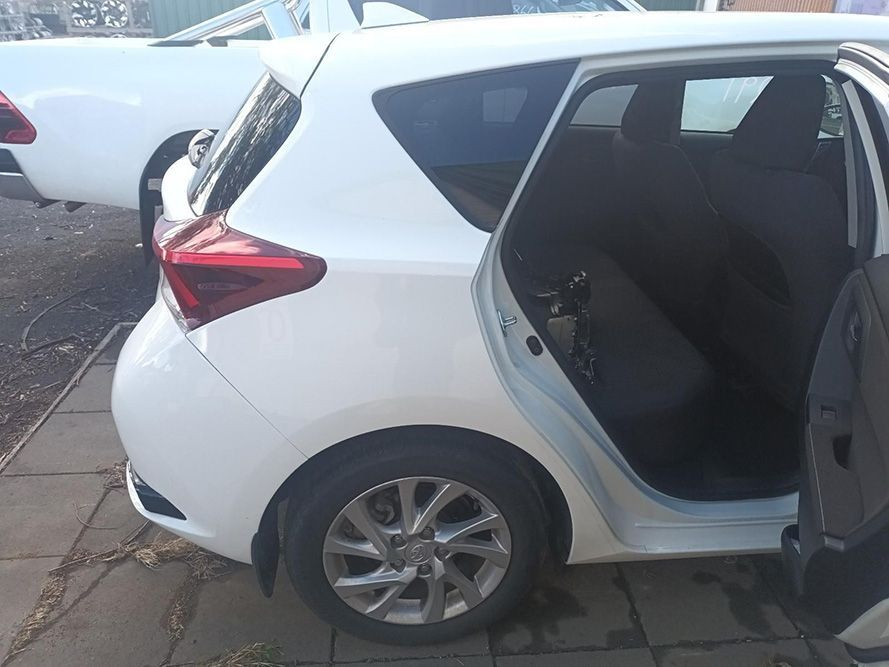 A White Car with the Door Open is Parked on a Sidewalk — South West 4WD Wreckers In Brisbane, QLD