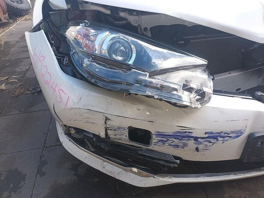 A White Car with a Damaged Front Bumper and Headlight — South West 4WD Wreckers In Brisbane, QLD