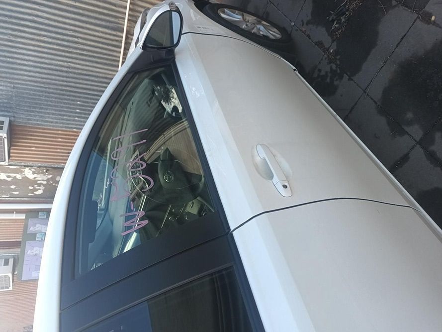 A White Car is Parked in Front of a Building — South West 4WD Wreckers In Brisbane, QLD