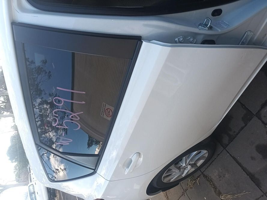 A White Car with the Door Open is Parked on a Sidewalk — South West 4WD Wreckers In Brisbane, QLD