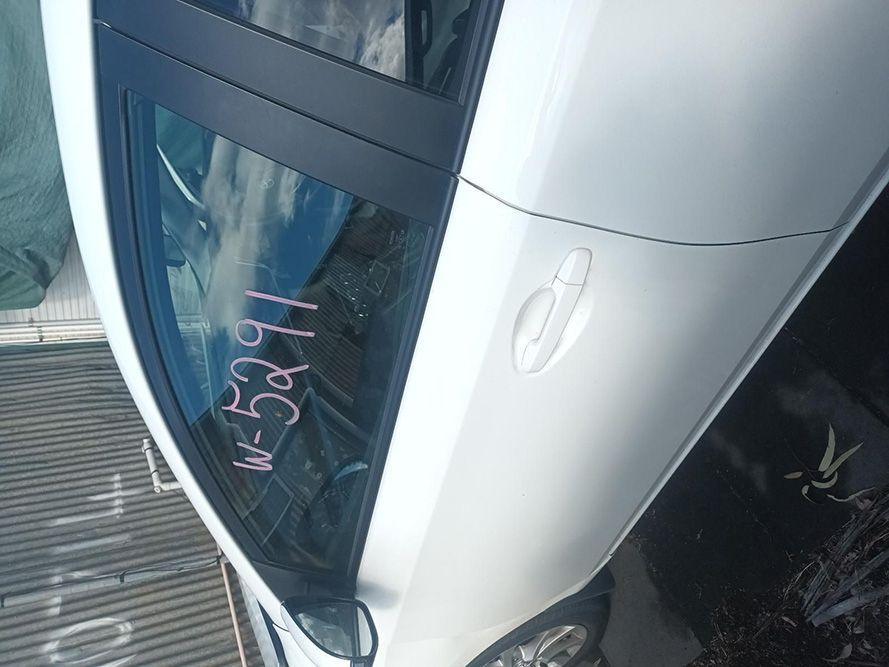 A White Car with a Numbers Written on the Door — South West 4WD Wreckers In Brisbane, QLD