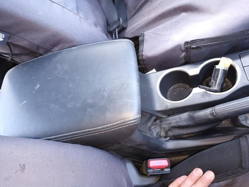 A Person is Holding a Cup Holder in a Car — South West 4WD Wreckers In Brisbane, QLD