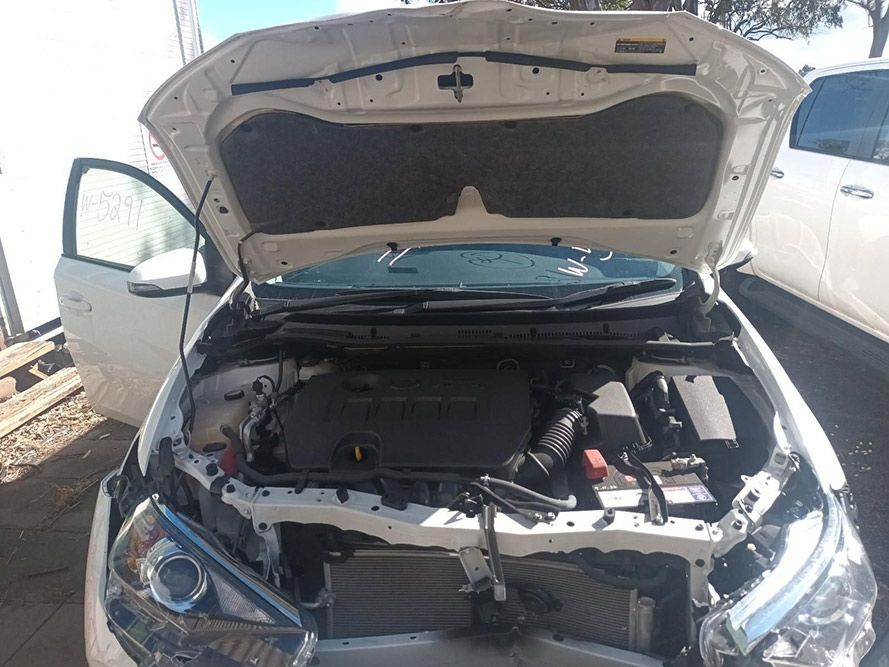 The Hood of a White Car is Open and the Engine is Visible — South West 4WD Wreckers In Brisbane, QLD