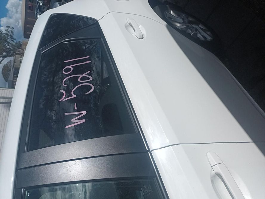 A White Car with a Written on the Back Window — South West 4WD Wreckers In Brisbane, QLD