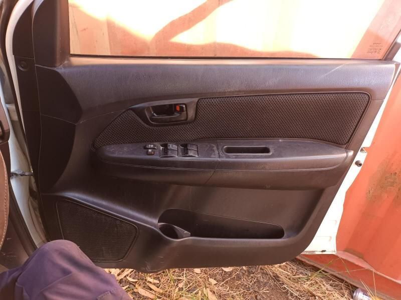 A Person is Sitting in the Door of a White Car — South West 4WD Wreckers In Brisbane, QLD