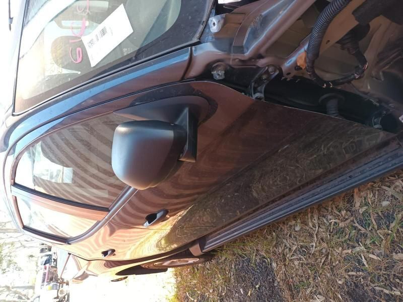 A Black Car is Parked in the Grass With the Door Open — South West 4WD Wreckers In Brisbane, QLD