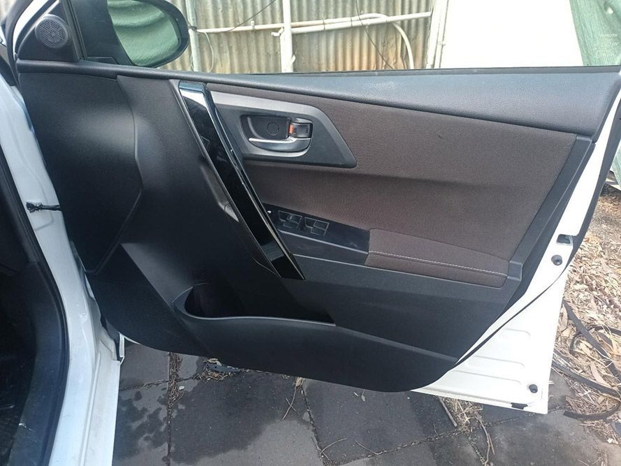 A White Car with the Door Open is Parked on the Side of the Road — South West 4WD Wreckers In Brisbane, QLD