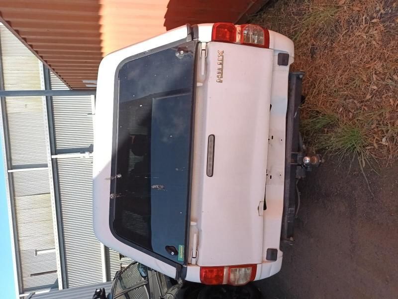 A White Hilux Truck is Parked on the Side of the Road — South West 4WD Wreckers In Brisbane, QLD