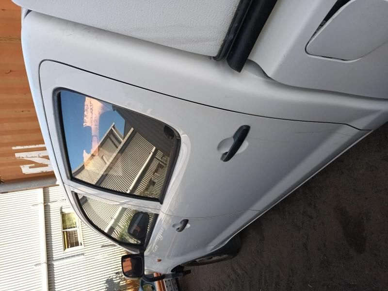 A White Car is Parked in Front of a Building With the Letter M on It — South West 4WD Wreckers In Brisbane, QLD