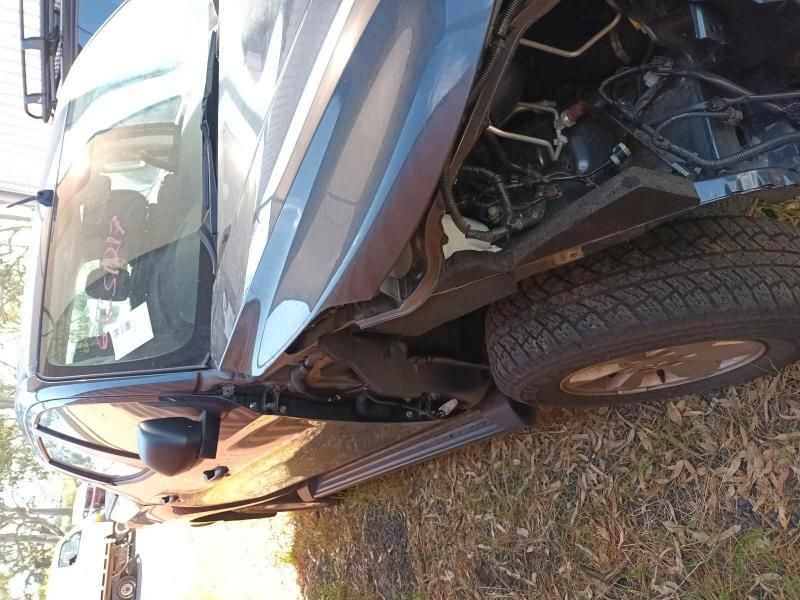 A Car That Has Been Damaged and is Sitting in the Grass — South West 4WD Wreckers In Brisbane, QLD