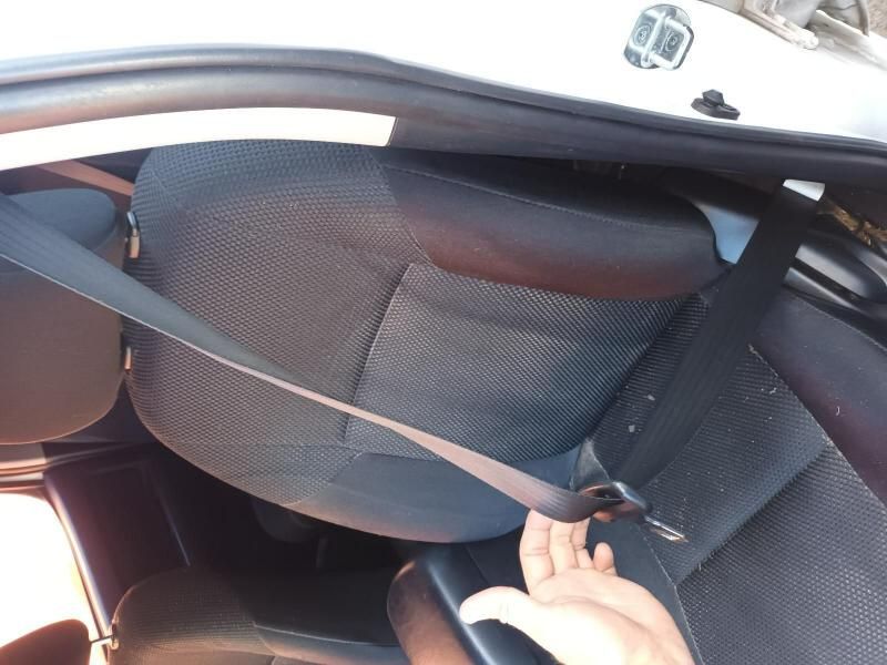 A Person is Putting on a Seat Belt in a Car — South West 4WD Wreckers In Brisbane, QLD