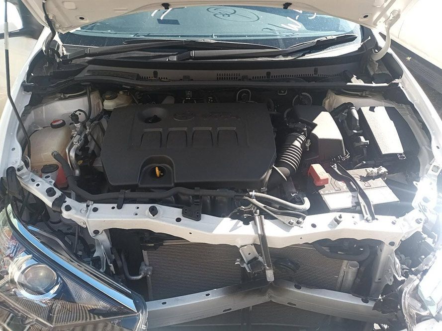 The Engine of a White Car is Shown with the Hood Up — South West 4WD Wreckers In Brisbane, QLD