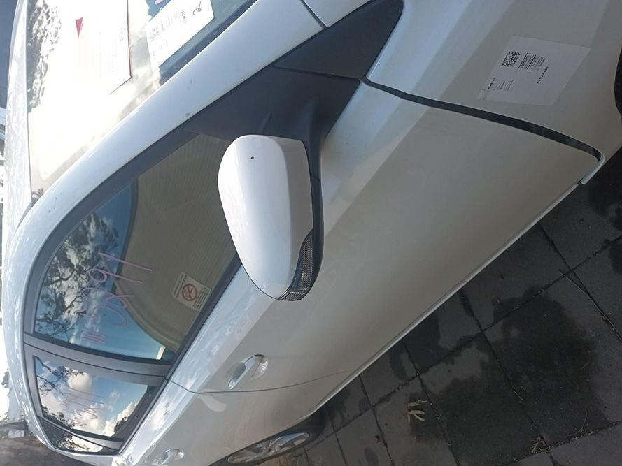 A White Car is Parked on the Side of the Road — South West 4WD Wreckers In Brisbane, QLD