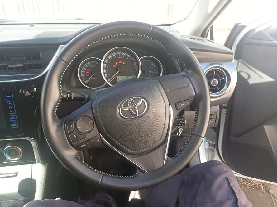 A Person is Sitting in the Driver's Seat of a Toyota Car — South West 4WD Wreckers In Brisbane, QLD