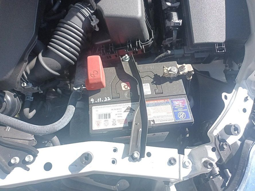 A Car Battery is Sitting Under the Hood of a Car — South West 4WD Wreckers In Brisbane, QLD