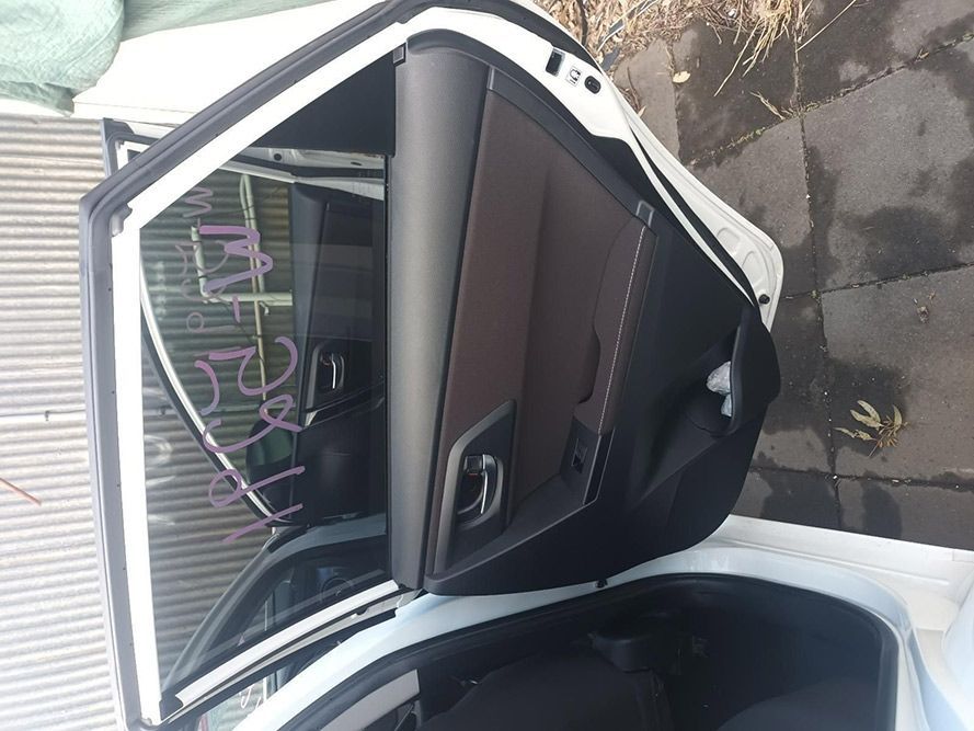 The Back Door of a White Car is Open — South West 4WD Wreckers In Brisbane, QLD