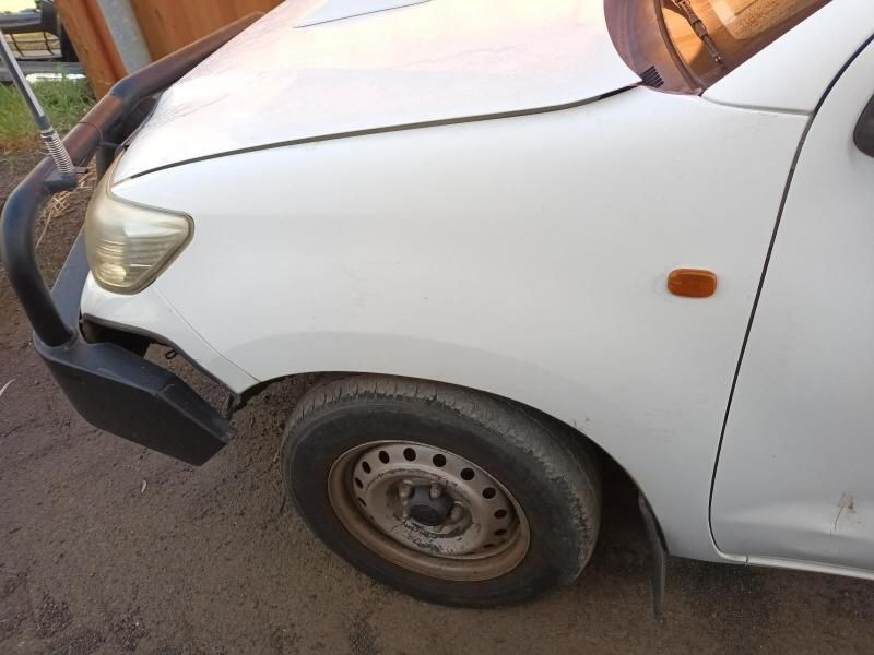 A White Car With a Black Bumper is Parked on a Dirt Road — South West 4WD Wreckers In Brisbane, QLD
