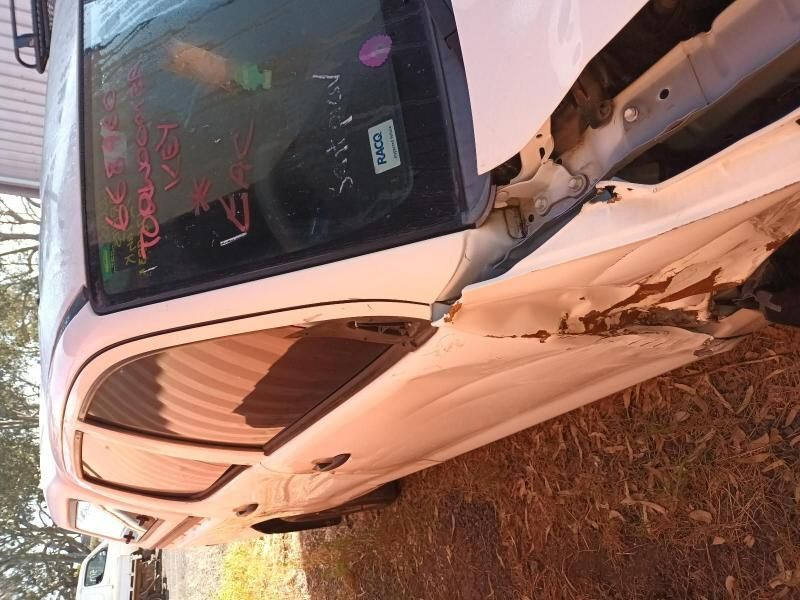 A White Car is Sitting on the Ground With the Door Open — South West 4WD Wreckers In Brisbane, QLD
