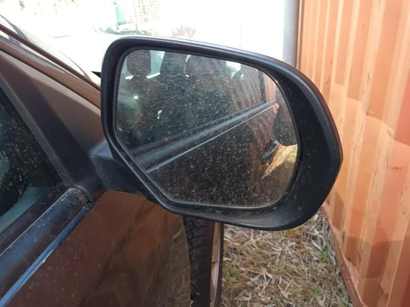 A Side View Mirror on a Car With a Wooden Fence in the Background — South West 4WD Wreckers In Brisbane, QLD