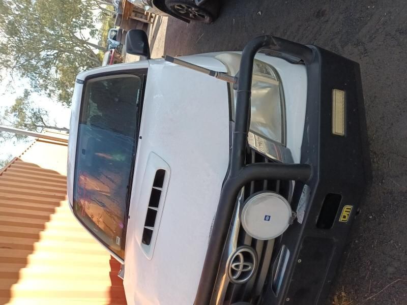 A White Toyota Truck is Parked on the Street — South West 4WD Wreckers In Brisbane, QLD