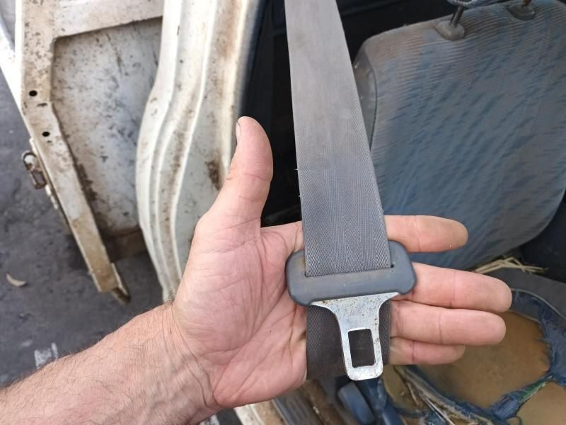 A Person is Holding a Seat Belt in Their Hand — South West 4WD Wreckers In Brisbane, QLD