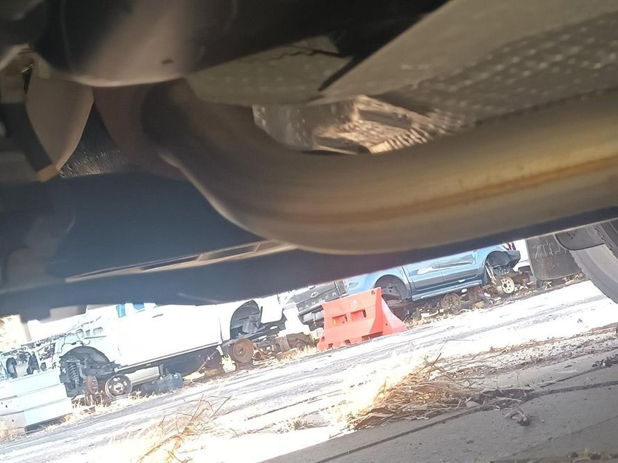 A Close Up of a Car Exhaust Pipe in a Parking Lot — South West 4WD Wreckers In Brisbane, QLD